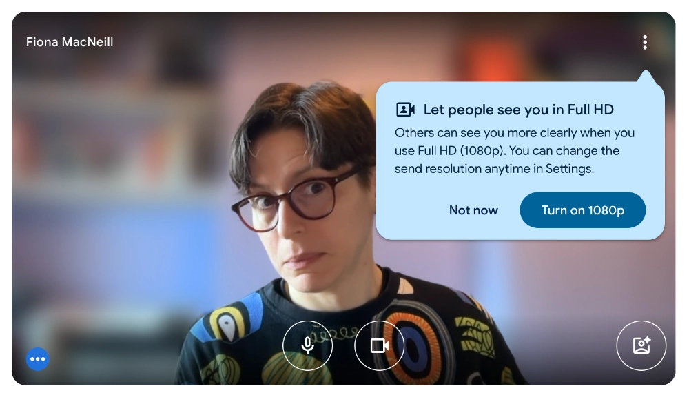 Screenshot of Fiona on a Google Meet call, a pop-up message has come up saying, Let people see you in Full HD - others can see you more clearly when you use Full HD (1080p). You can change the sent resolution anytime in Settings. Fiona looks askance at this suggestion.