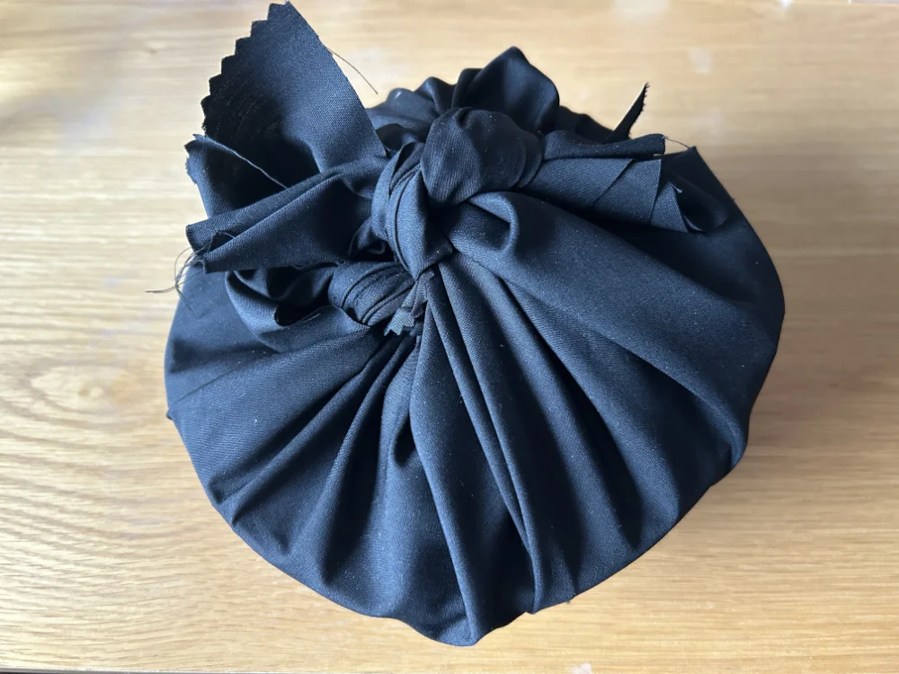 A mysterious basket wrapped in black cloth