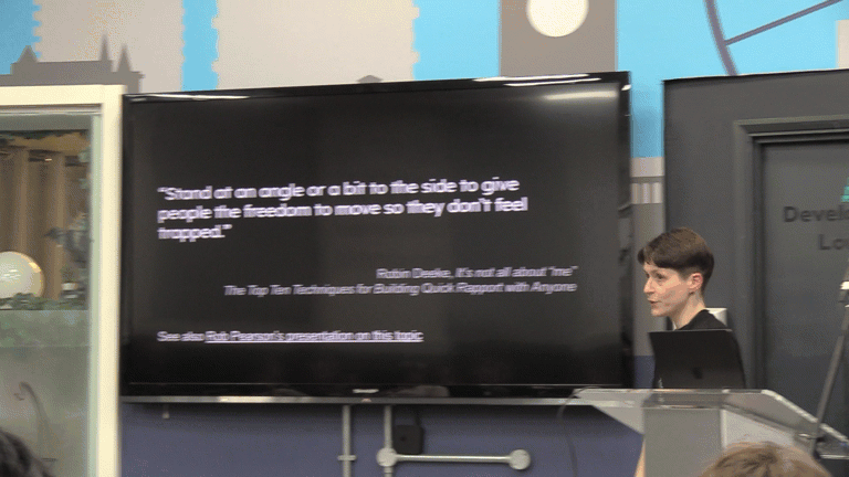 Fiona is mid presentation, puts down the microphone and throws a demonstrative side kick towards the audience